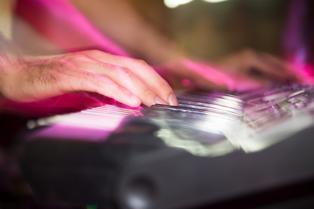 Musician plays keyboards in a rock band .の写真素材