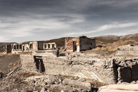The ruins of an old house in nature .
