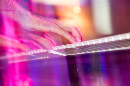 Musician plays keyboards in a rock band .の写真素材