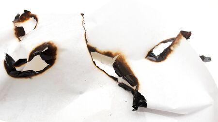 Trail of burnt paper on white background .