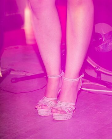 Feet of a girl on stilettos on stage .の写真素材