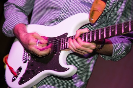 Musician playing guitar in a rock band .の写真素材