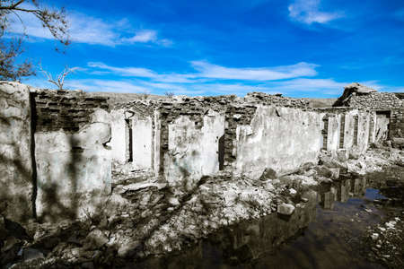 The ruins of an old house against the blue sky .の写真素材