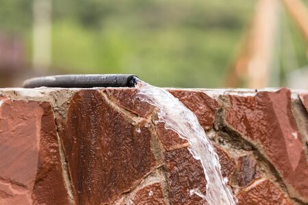 Water from a hose on a granite .の写真素材