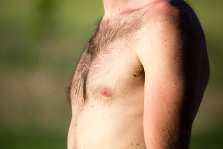 Hairy chest of a man in the open air .の写真素材