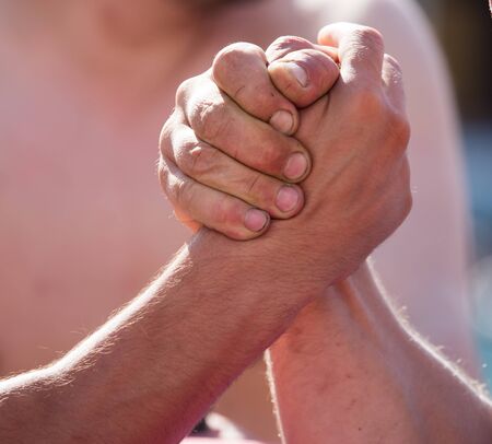 Two men's hands in comparison strength .