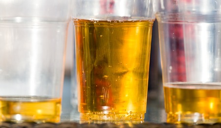 Beer in a plastic glass on the table .の写真素材