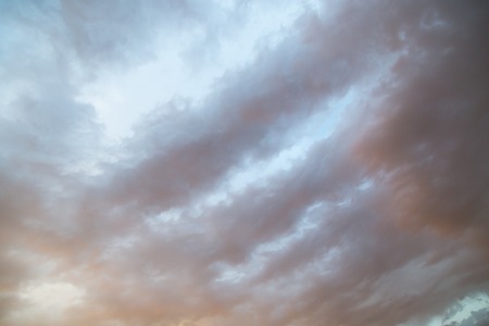 Background of beautiful rain clouds at sunsetの写真素材