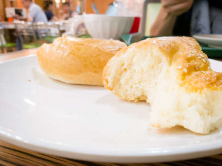 Bread on a white plate in a cafe .