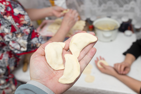 Cook cooks vareniki with potatoes in the kitchenの写真素材