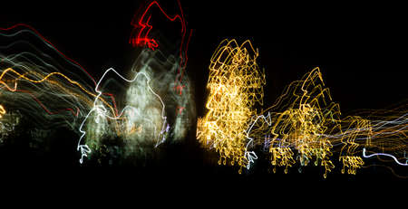Abstract background of light bulbs at night in motion .