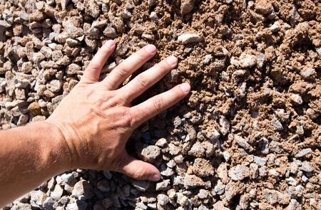 Building crushed stone with sand in hand .の写真素材