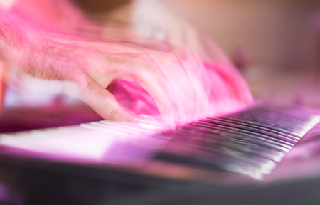 Musician plays keyboards in a rock band .の写真素材