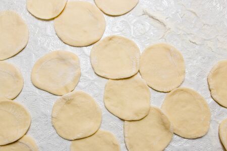 Cook cooks dough for pieces in the kitchenの写真素材