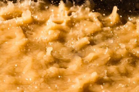 Rain drops fall into a dirty puddle .の写真素材