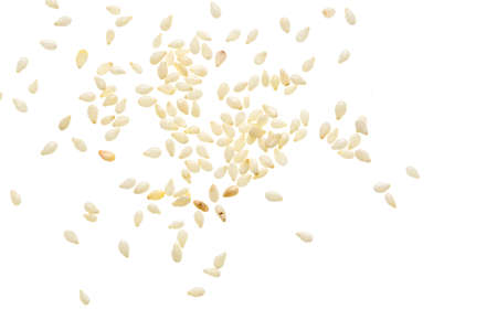 Sesame seeds scattered and isolated on white backgroundの写真素材