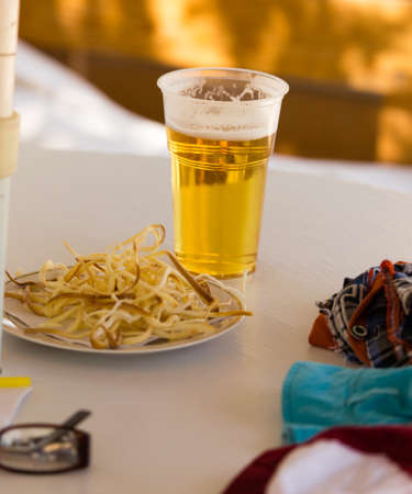 Beer in a glass on a table in a cafeの写真素材