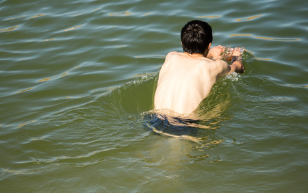 The man is swimming in the lakeの写真素材