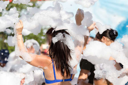 Youth at a foamy party on the beachの写真素材