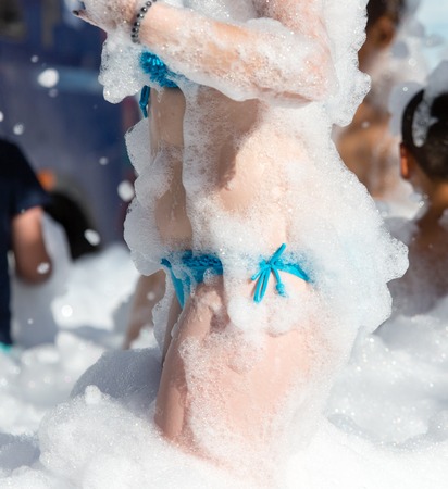 Youth at a foamy party on the beachの写真素材