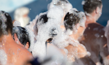 Youth at a foamy party on the beachの写真素材