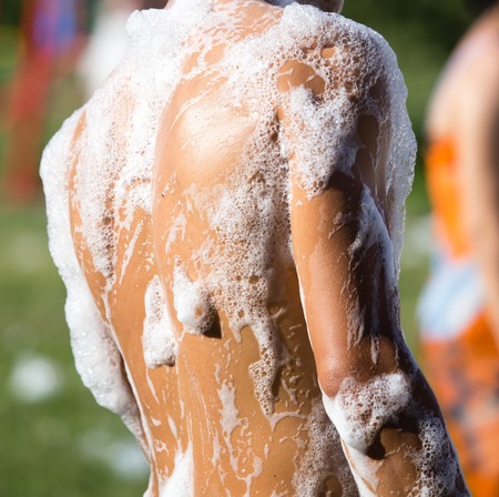 Youth at a foamy party on the beachの写真素材