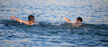 The man is swimming in the lakeの写真素材