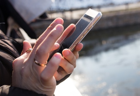 Cell phone in the hands of manの写真素材