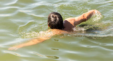 The man is swimming in the lakeの写真素材