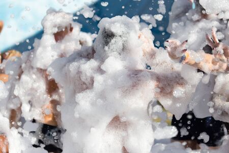 Youth at a foamy party on the beachの写真素材