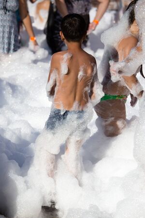 Youth at a foamy party on the beachの写真素材