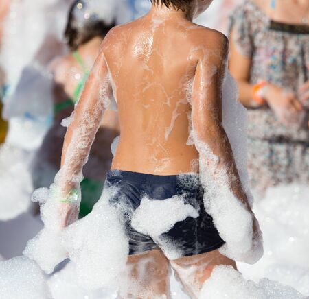 Youth at a foamy party on the beachの写真素材