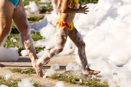 Youth at a foamy party on the beachの写真素材