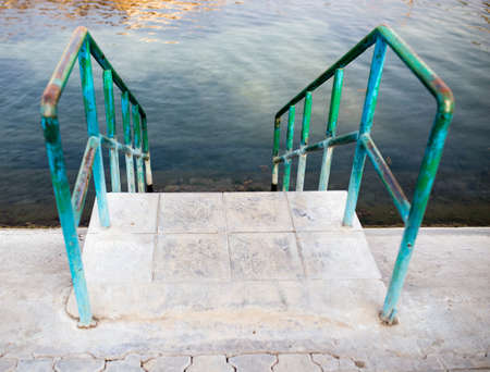 Stairs to the water of the swimming poolの写真素材