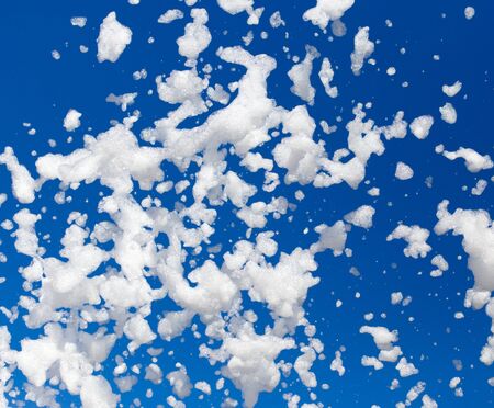 White foam against the blue sky as backgroundの写真素材