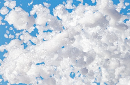 White foam against the blue sky as backgroundの写真素材