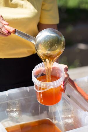 the beekeeper sells honey in the marketの写真素材