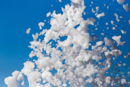 White foam against the blue sky as background