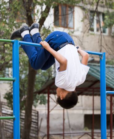 Boy training on a horizontal barの写真素材
