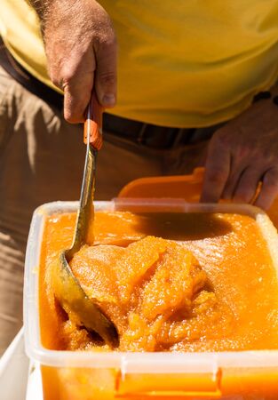 the beekeeper sells honey in the marketの写真素材