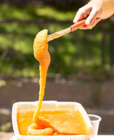 the beekeeper sells honey in the marketの写真素材