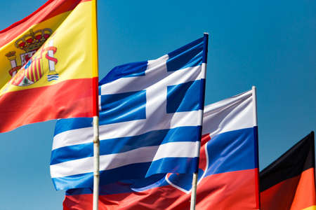 flags of different countries against the blue skyの写真素材