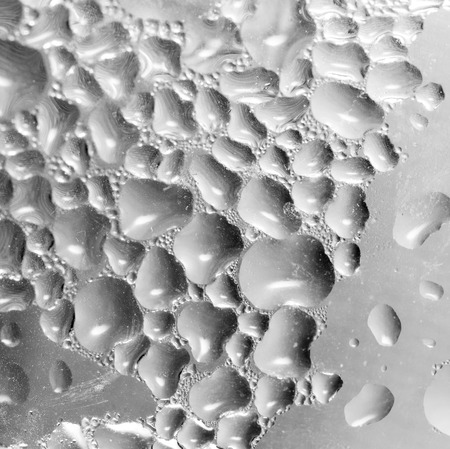 abstract background of drops on gray glassの写真素材