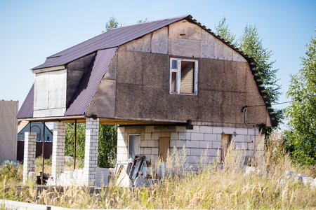 brick cottage house with a roof in the townの写真素材