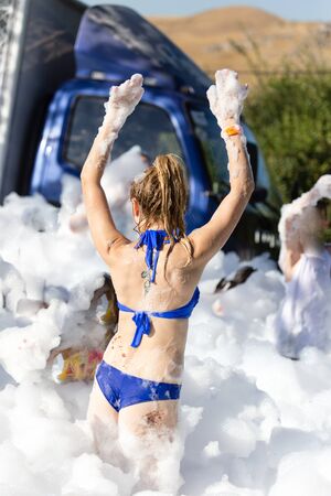 Youth at a foamy party on the beach .の写真素材