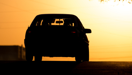 car rides on the road at sunset .の写真素材