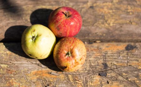 ripe three apples on a wooden backgroundの写真素材
