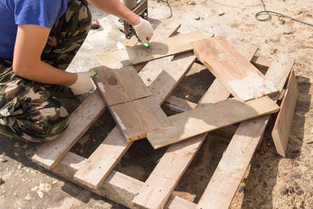 worker working with wooden planks at construction site .の写真素材