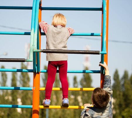 children climb on the stairs in the park .の写真素材