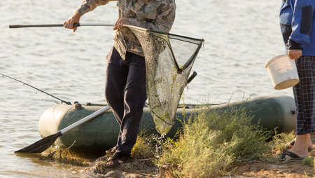 the fisherman catches fish on the river bank .の写真素材
